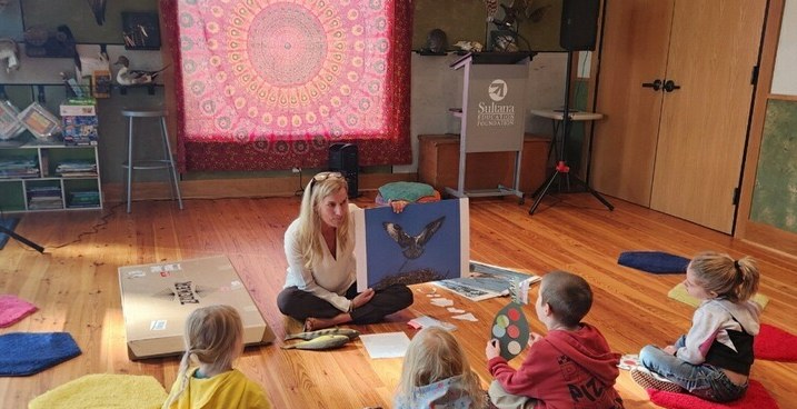 Letitia Burton sharing Soar with children seated on cushions during the Downrigging Festival in Chestertown, Maryland